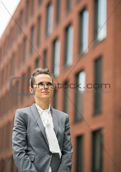 Portrait of business woman in front of office building