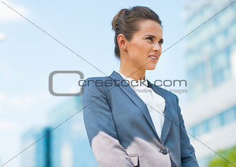 Portrait of happy business woman in office district