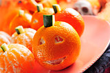 mandarines ornamented as Halloween pumpkins