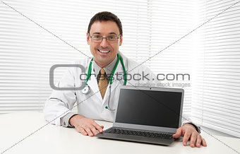 Doctor sitting at his desk with laptop