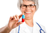 Female doctor holding  a pill