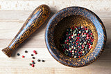 Red, black, green and white peppercorns