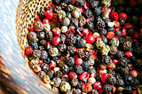 Red, black, green and white peppercorns