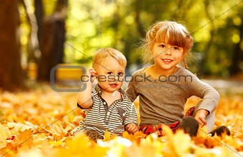 beautiful little girl with a little brother in the autumn park p