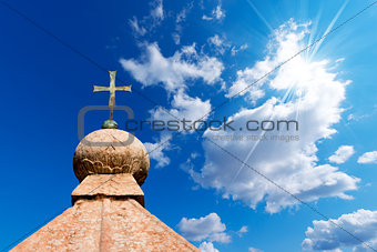 Bronze Cross on Blue Sky