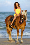 Beautiful young woman riding a horse