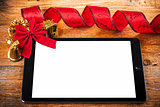 tablet pc with  christmas decorations on wooden background