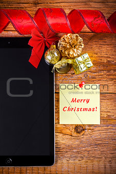 tablet pc with  christmas decorations on wooden background