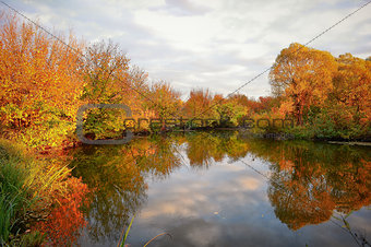 Landscape with colorful autumn trees reflected in the river