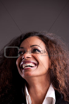 Happy afroamerican girl looking up laughing 
