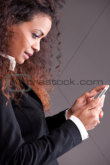 beaufitul afro-american curly girl watching her mobile