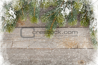 Old wood texture with snow and firtree