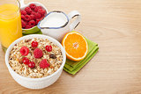 Healty breakfast with muesli, berries, milk and orange juice