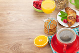 Healthy breakfast with muesli, berries, orange juice, coffee and