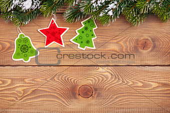 Christmas fir tree with snow and holiday decor on rustic wooden 
