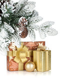Gift box and christmas decor under snowy fir tree