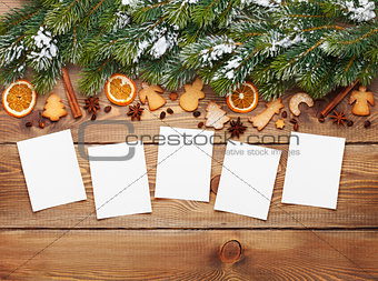 Christmas background with photo frames, snow fir tree, spices an