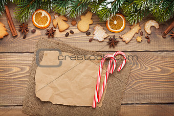 Christmas background with snow fir tree, spices, gingerbread coo