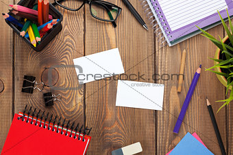 Office table with notepad, colorful pencils, supplies and busine
