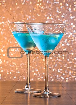 glasses of fresh blue cocktail with ice on bar table