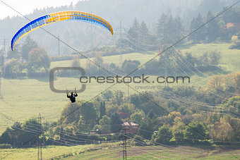 Paraglider over high voltage pylons and lines
