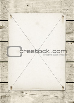 Blank vintage poster nailed on a white wood board