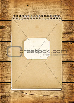Blank vintage notebook on a wood board
