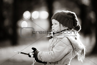 Cute little girl on playground in autumnal park