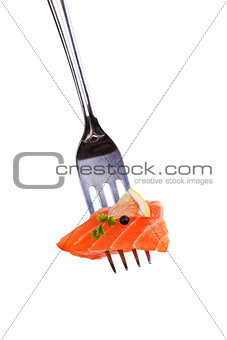Delicious salmon piece on fork.