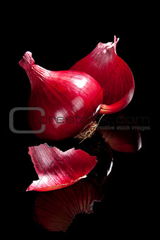 Red onion isolated on black.