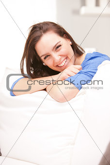 Happy smiling woman in her white living room