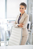 Thoughtful business woman standing in office
