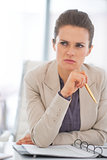 Portrait of thoughtful business woman in office