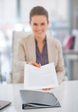 Closeup on happy business woman giving document