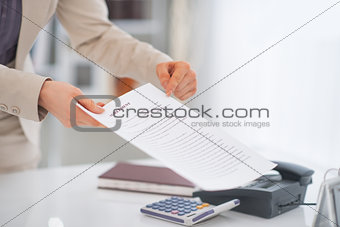 Closeup on business woman pointing on document