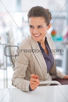 Happy business woman with eyeglasses in office