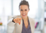 Closeup on happy business woman pointing in camera