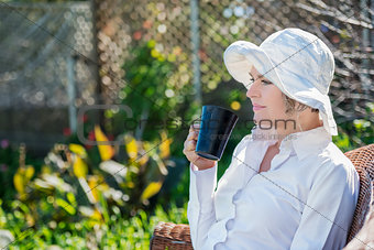 Woman  with cup in the garden