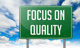 Focus on Quality in Green Highway Signpost.