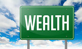 Wealth on Green Highway Signpost.