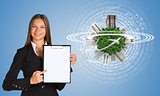 Beautiful businesswoman holding paper holder. Earth with buildings and figures