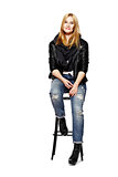 Rock style girl sitting on stool