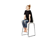Portrait of a young woman sitting on modern chair
