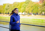 Young Beautiful Woman Running in the Autumn Park