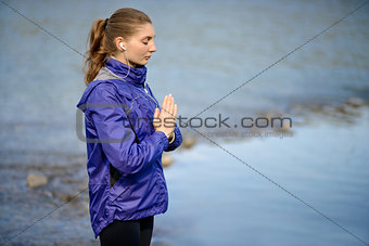 Young Beautiful Woman Meditate on the River