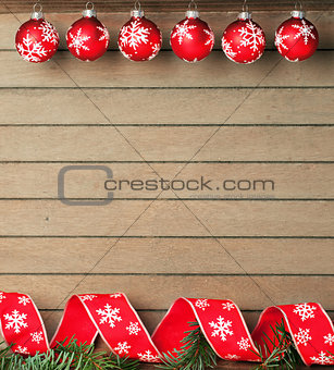 Ribbon and baubles on wooden background