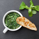 Sauteed garlic spinach dish, baked bread slice  with  melted che