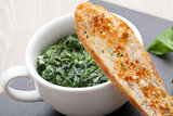 Sauteed garlic spinach dish, baked bread slice  with  melted che