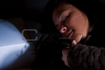 Girl sleeping on a couch in half-light
