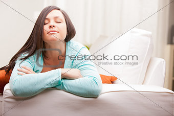 relaxed woman thinking on her sofa